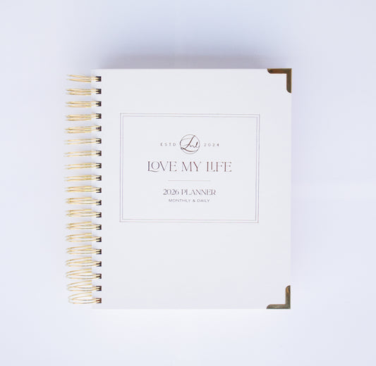 Planner with gold spiral binding on a white background