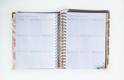 Open planner with floral design on a white background