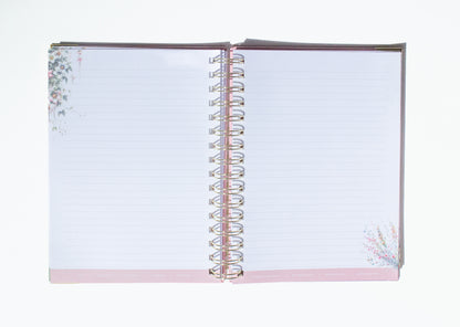 Open notebook with floral design on a white background
