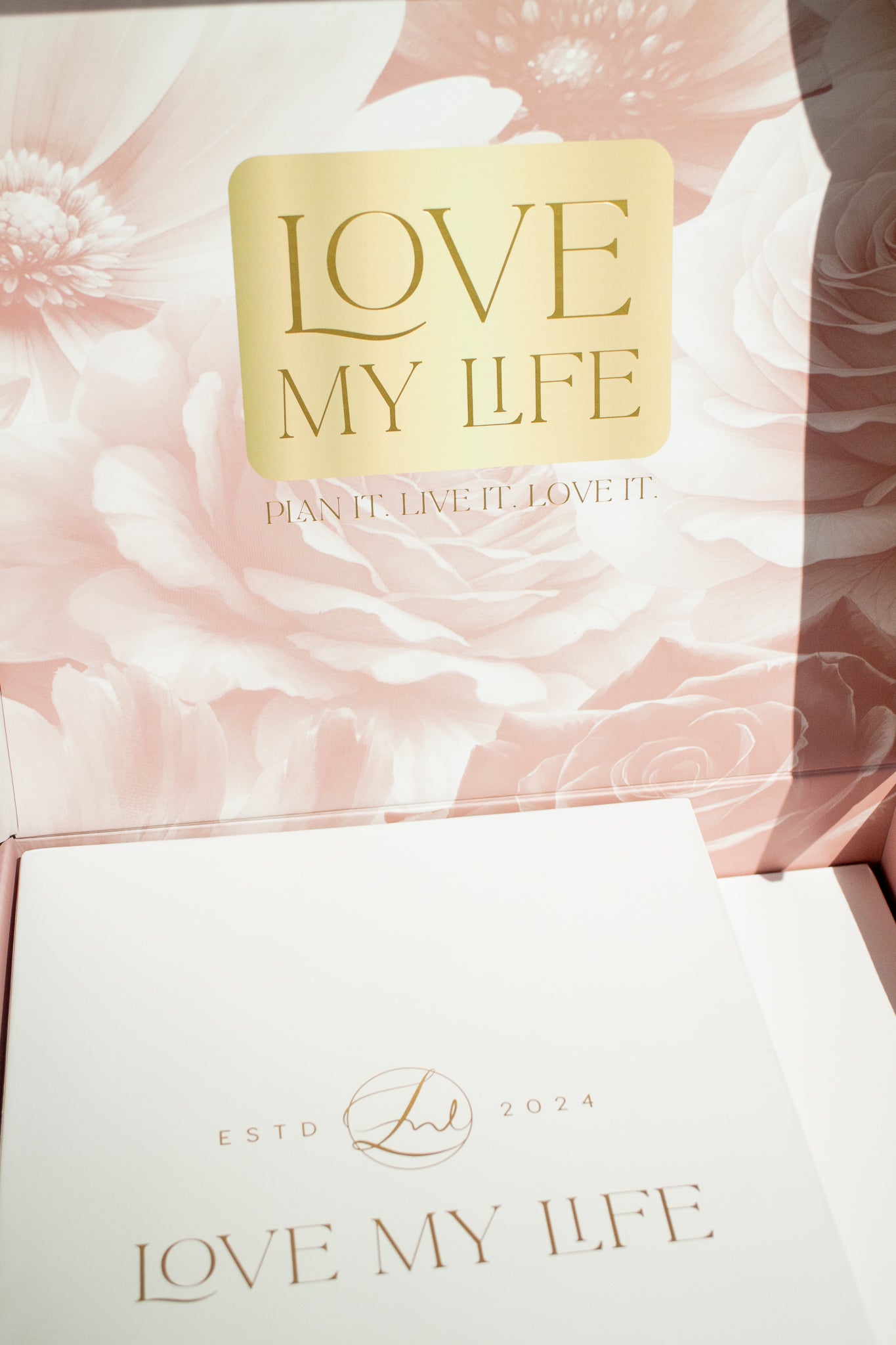 Product packaging with 'Love My Life' branding on a floral background