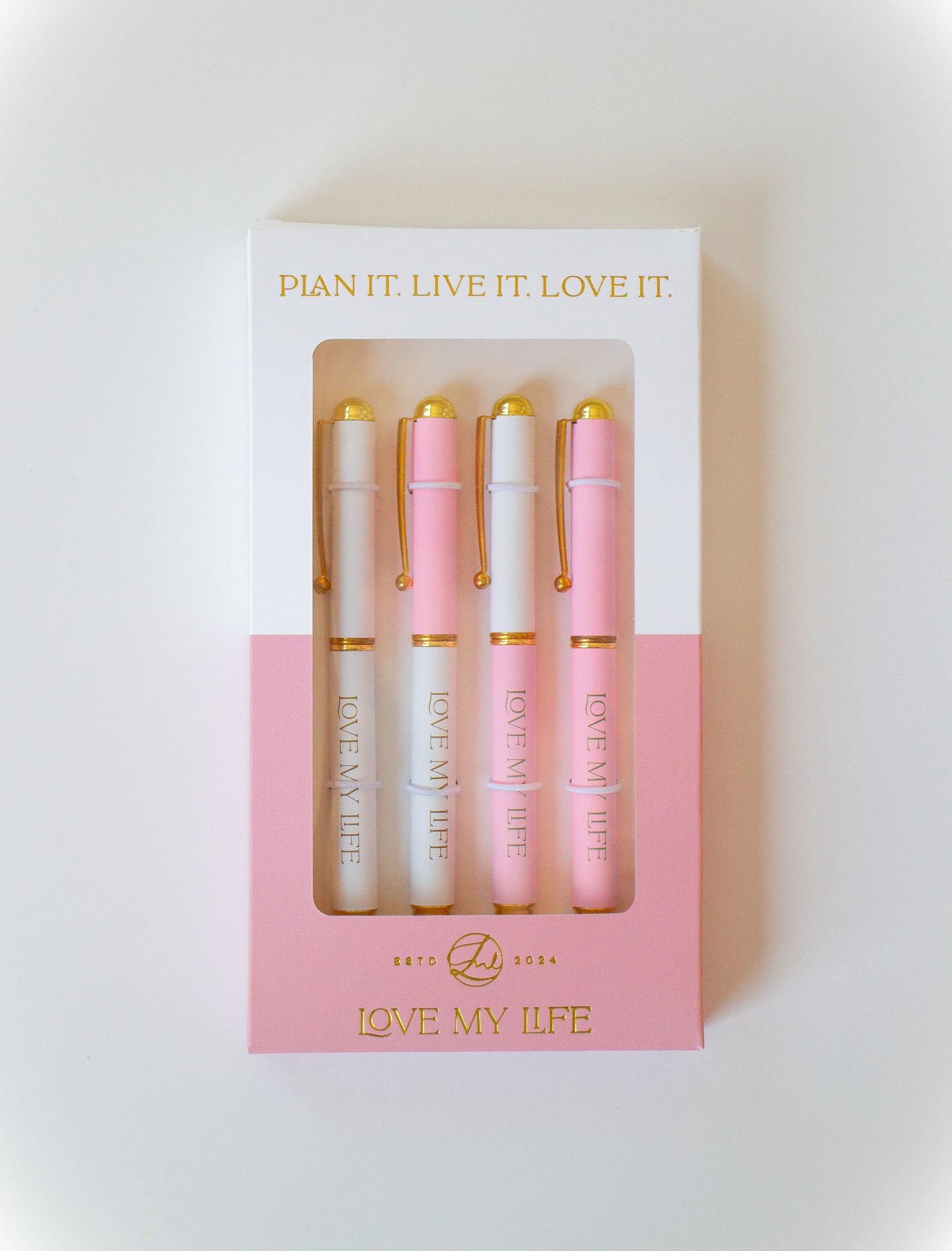 Set of pink and gold pens in a box with 'Love My Life' branding on a light background.