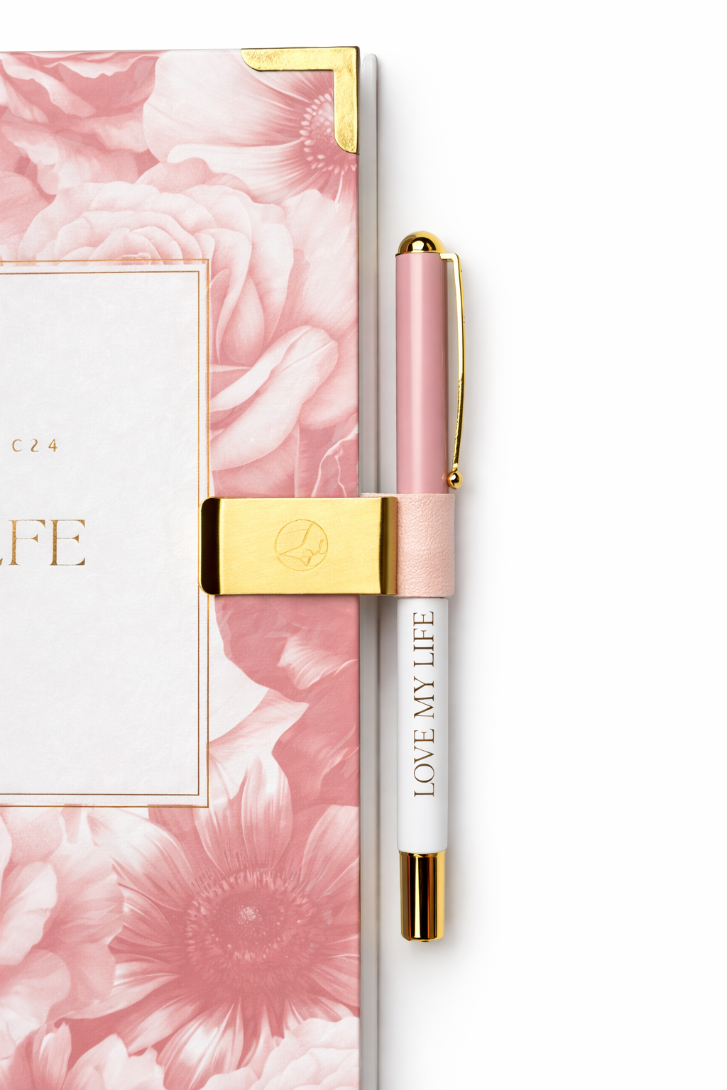 Pink pen with gold accents and matching packaging featuring floral design on a white background
