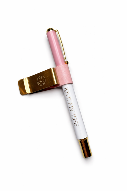 Pink and gold pen with white body on a white background