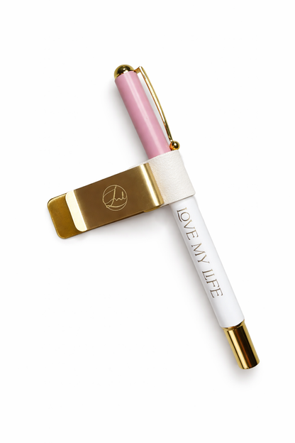 Pen with pink cap and gold accents on a white background
