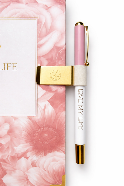 Pen with pink accents and 'LOVE MY LIFE' packaging on a white background